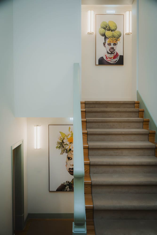 Staircase at Once Upon Lisboa with a painting on the wall